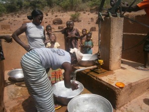 Women collecting water at a well in rural Burkina Faso, West Africa