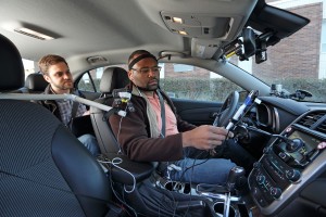 A University of Utah research assistant introduces a participant in new distracted driving studies to special devices designed to gauge mental distraction during road tests.